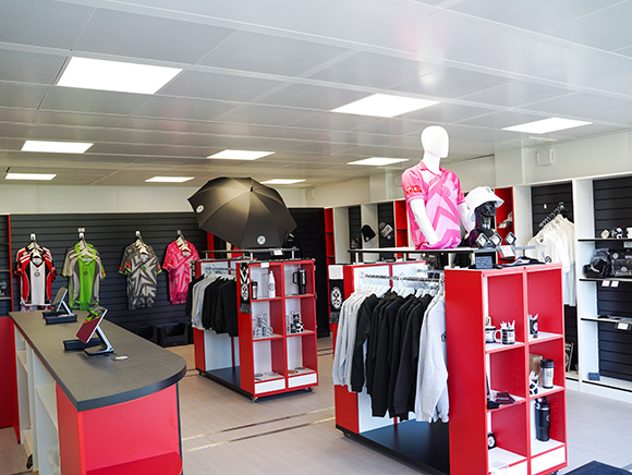 Modular retail unit interior fitted with shelving, display racks, and checkout counter, providing a flexible pop-up shop and merchandising space.