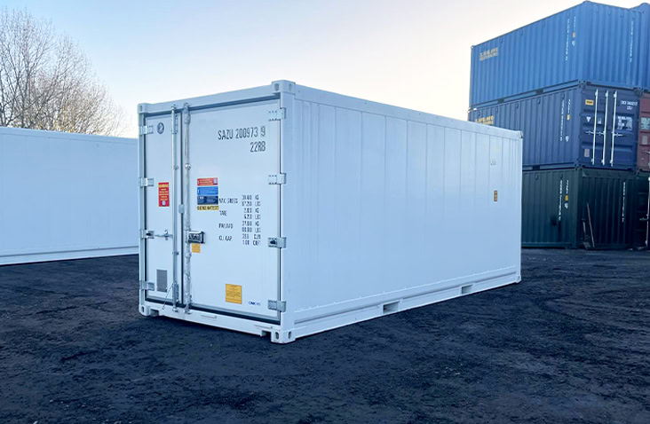 20ft white refrigerated shipping container viewed from the front and side, with closed double doors featuring safety labels and specification markings. 