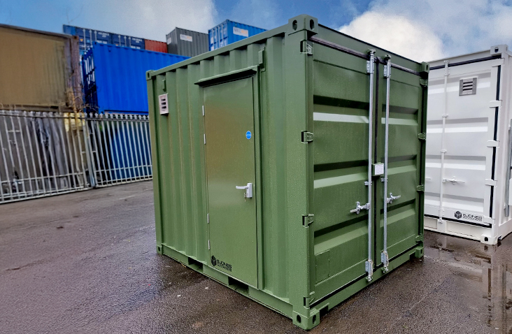 Green 10ft battery storage unit with personnel access door and cargo doors, designed and manufactured by S Jones Conversions.