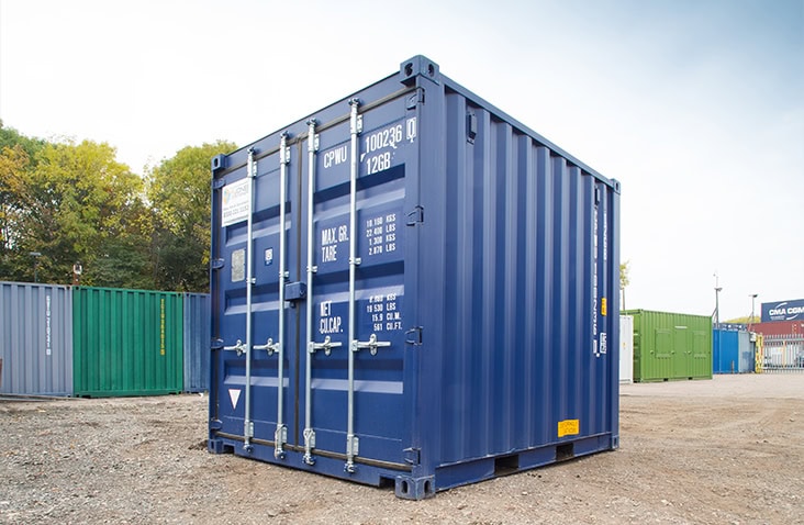 Blue 10ft shipping container with closed double doors, corner castings, and painted weight specification markings. 