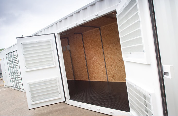 Insulated and ventilated shipping container with OSB internal lining and anti-slip flooring, shown with open double doors. 