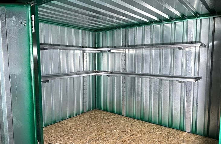     Interior of a flat pack steel storage unit with an optional metal shelf kit installed for organised storage. 