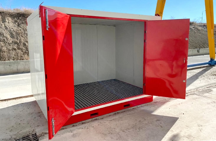 White insulated flat pack chemical storage unit with red double doors open, showing insulated interior walls and a bunded steel floor for COSHH-compliant hazardous liquid storage