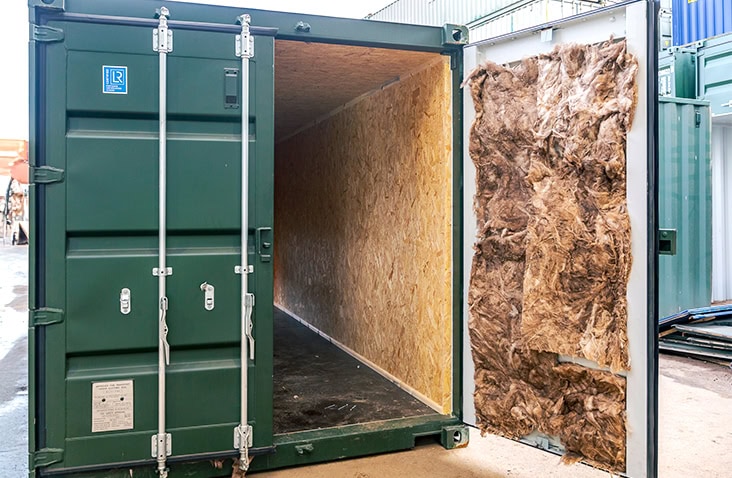 Mineral wool insulation installed inside a shipping container door as part of a container lining system. 
