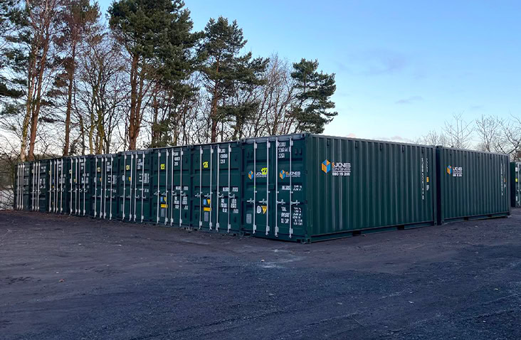 External self storage site with rows of dark green shipping containers supplied by S Jones Containers for storage rental, container hire and container sales. 
