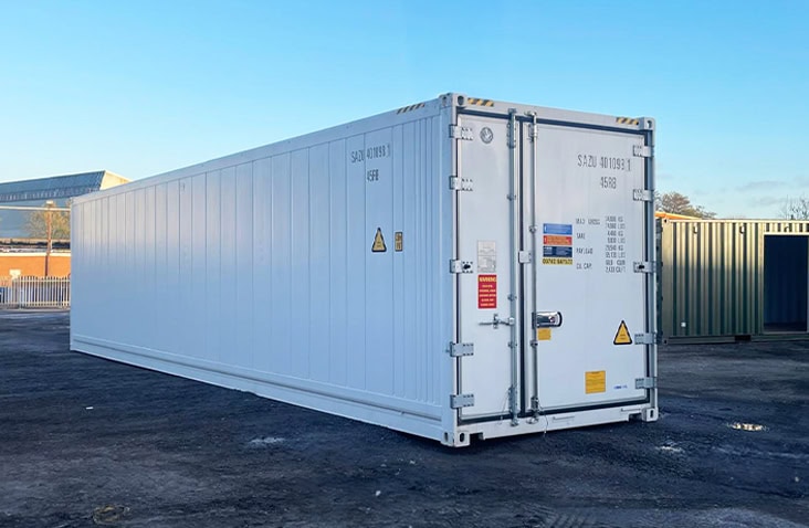 40ft white refrigerated shipping container viewed from the front and side, with closed doors featuring safety labels and container specification details. 