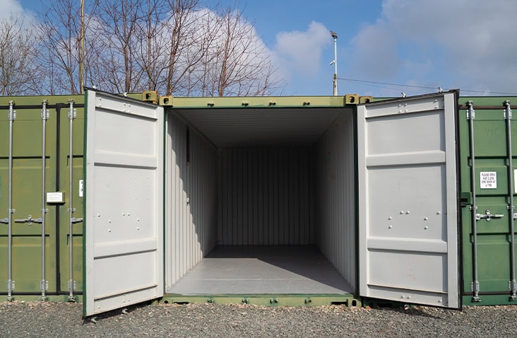 Open 20ft self storage container showing empty secure steel interior, suitable for container hire and storage rental on a gravel yard. 