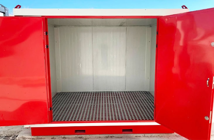 Front view of an insulated flat pack chemical storage unit with red double doors open, revealing white insulated interior walls and a bunded steel floor for COSHH-compliant hazardous liquid storage