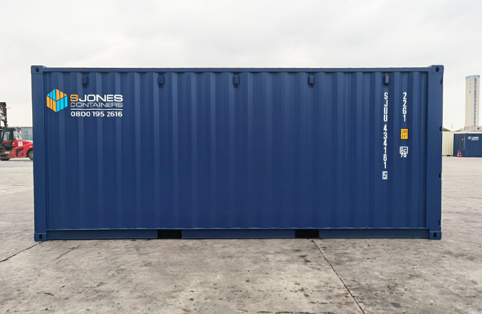 Side profile of a blue 20ft shipping container with corrugated steel wall and painted identification numbers.