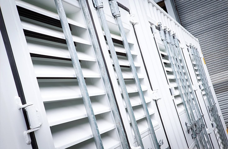 White shipping container doors fitted with multiple louvred ventilation panels for improved airflow. 