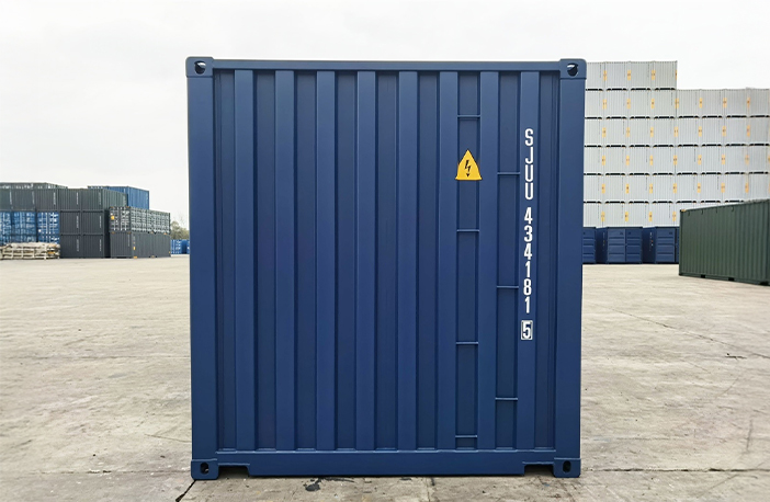 Rear end of a blue 20ft shipping container with solid corrugated steel panel and identification markings.
