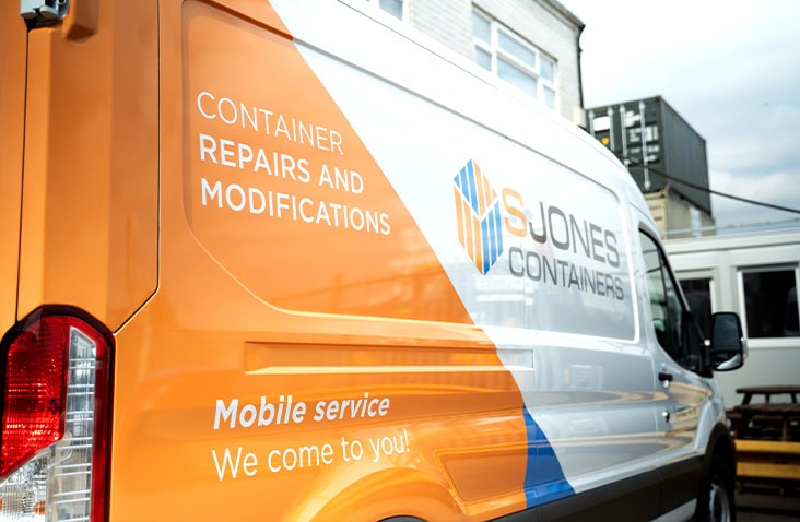 S Jones Containers mobile service van promoting on-site shipping container repairs and modifications.