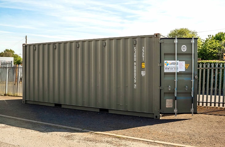 20ft steel shipping container in green livery positioned on an industrial yard, with S Jones Containers branding displayed on the front doors.