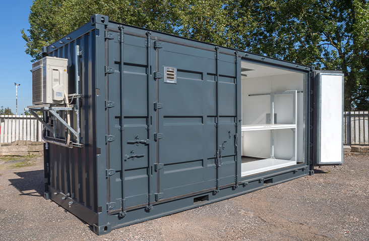 Climate-controlled battery storage unit with side access door open, showing internal racking and ventilation system.