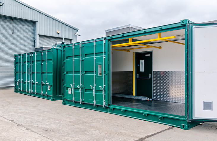 Green battery storage units with full side opening access and internal safety linings, manufactured by S Jones Conversions.