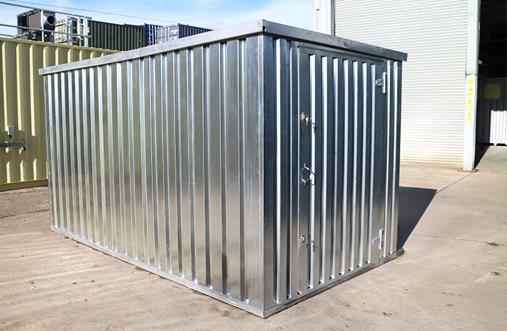 Galvanised 2m x 3m flat pack storage unit assembled outdoors on a concrete surface with door closed. 