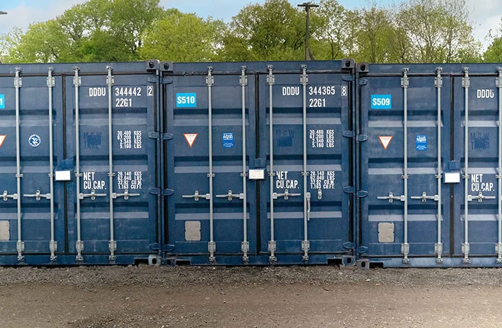 Row of blue shipping containers after ClearRestore® treatment, showing a richer colour and refreshed exterior