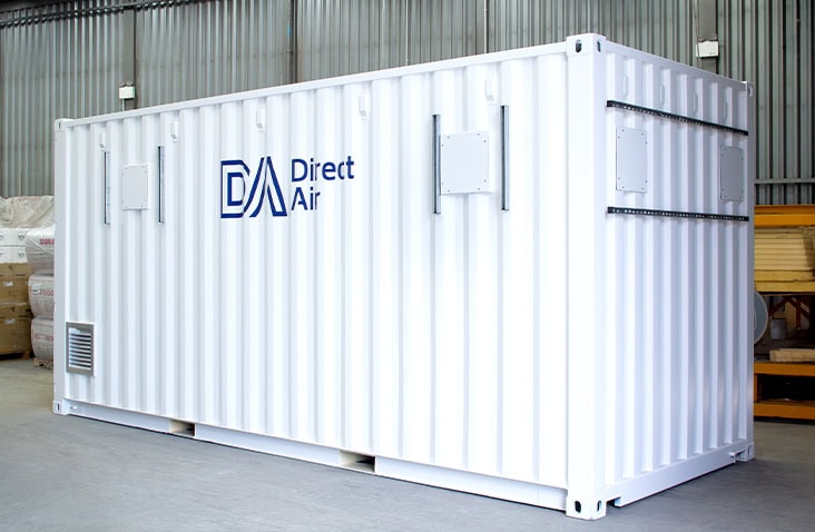 20ft control and air equipment room built from a converted shipping container, showing a white containerised plant room with ventilation panels, access hatches and Direct Air branding, designed to house control systems and air handling equipment. 