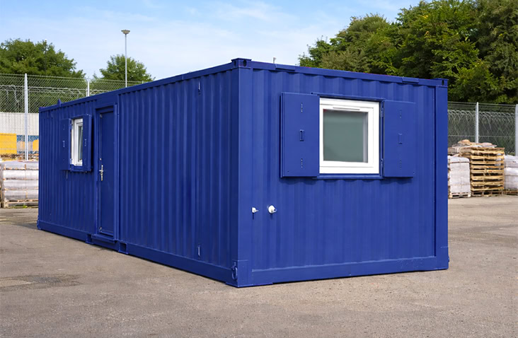 32ft blue steel site accommodation welfare unit with external access door and shuttered window, designed for construction site hire, providing secure on-site welfare, office or canteen facilities. 