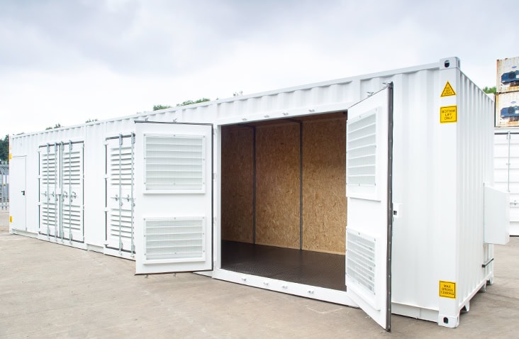 Interior view of a 40ft compressor housing container, showing OSB-lined walls, heavy-duty flooring and wide-opening vented doors designed to house industrial compressors and plant equipment. 