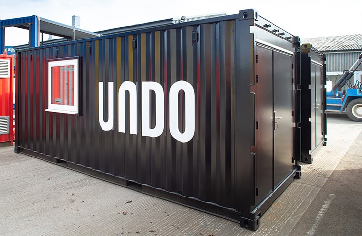UNDO branded mobile laboratory converted from a shipping container, featuring insulated steel doors, security locking system, window installation and bespoke exterior finish by S Jones Conversions. 