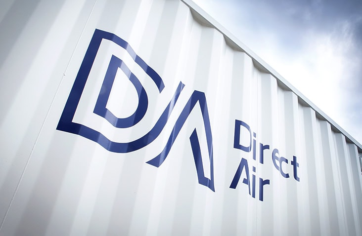 Direct Air branding on a converted shipping container, showing the Direct Air logo and company name applied to the exterior of a white containerised plant or control room unit.