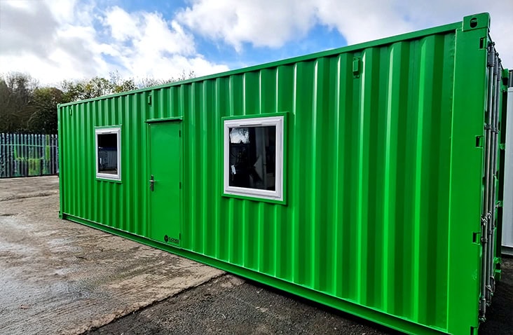 Exterior of an NPK recovery workshop and laboratory built from a shipping container, showing a green converted container with personnel door, windows and secure structure designed for nutrient recovery and laboratory operations.
