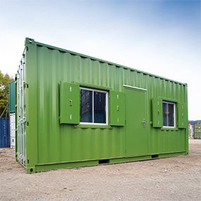 Green converted shipping container office with steel personnel door and shuttered windows, providing a secure and portable workspace solution.