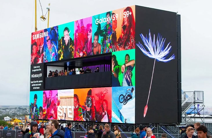 Large-scale containerised experiential platform built using shipping containers, displaying Samsung Galaxy S9+ digital screens and crowd engagement at a live outdoor event.